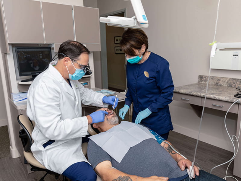 Dr. Filippi shows a patient how multiple dental implants is done