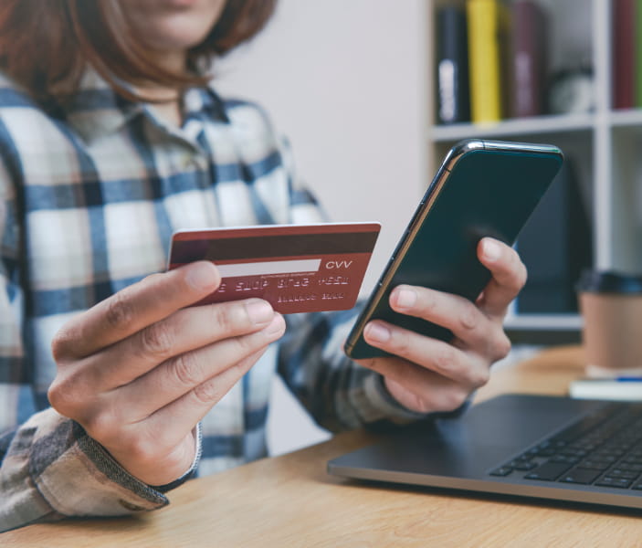 woman with credit cards paying bills
