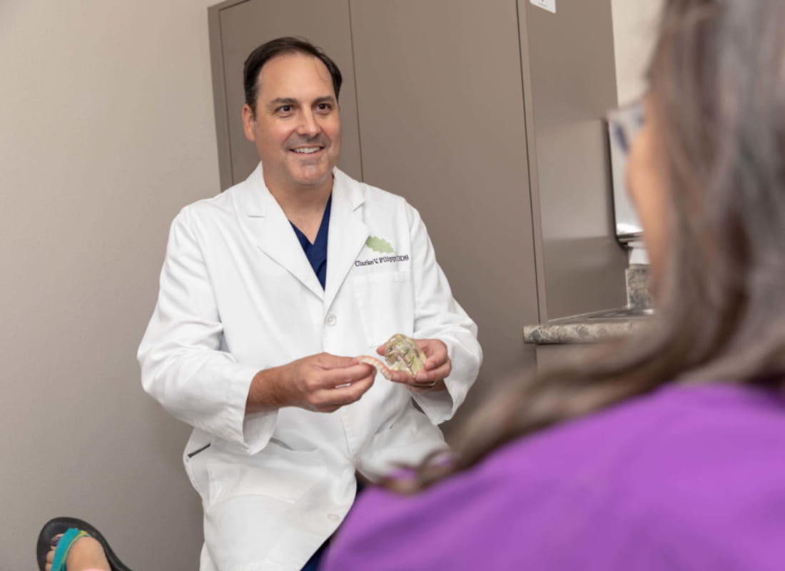 Doctor showing a patient what a denture looks like.