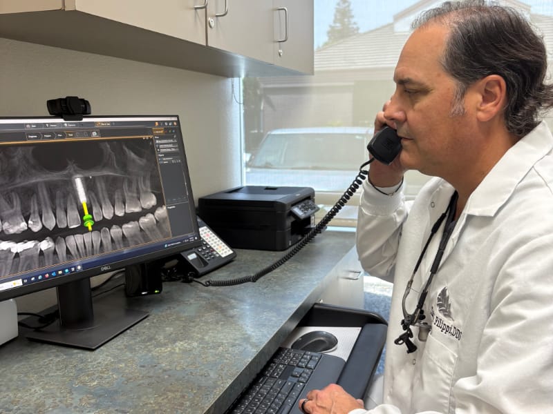 Dr. Filippi shows a patient how multiple dental implants is done